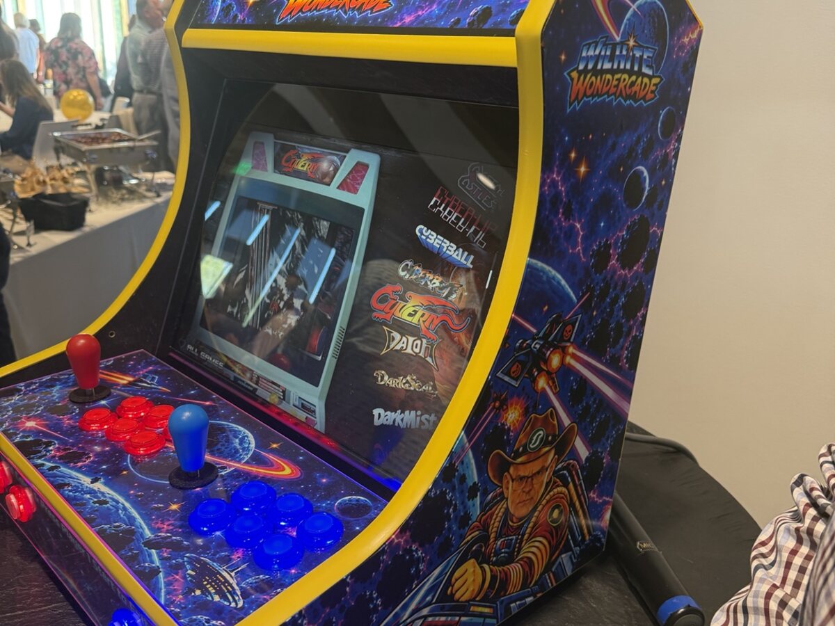 Finished bartop arcade retrofit powered on with galaxy artwork and yellow trim